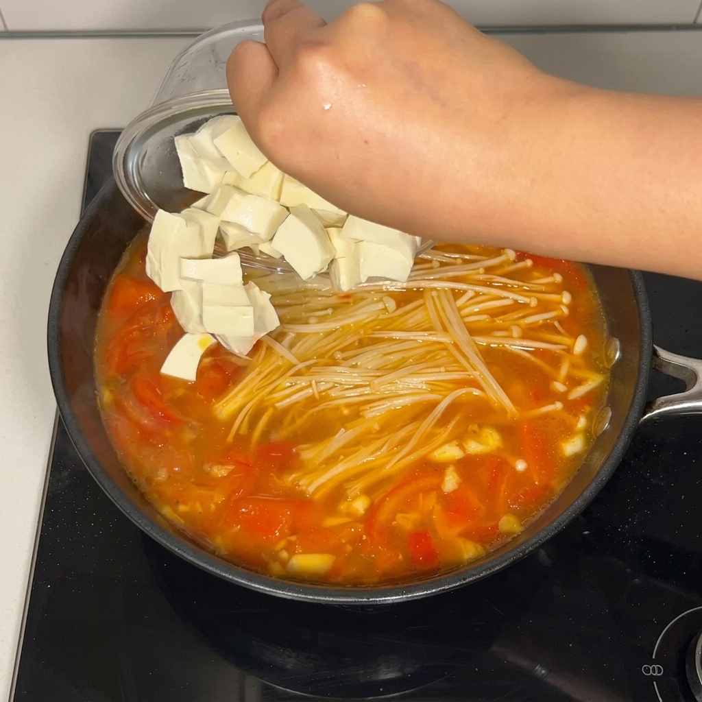 Dés de tofu soyeux déposés dans la soupe.