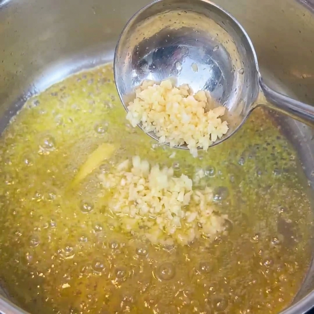 De lail haché remué dans le beurre fondu dans une poêle.
