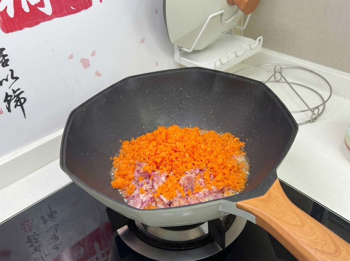 Un mélange coloré de carottes et doignons finement hachés cuisant dans un wok chaud.