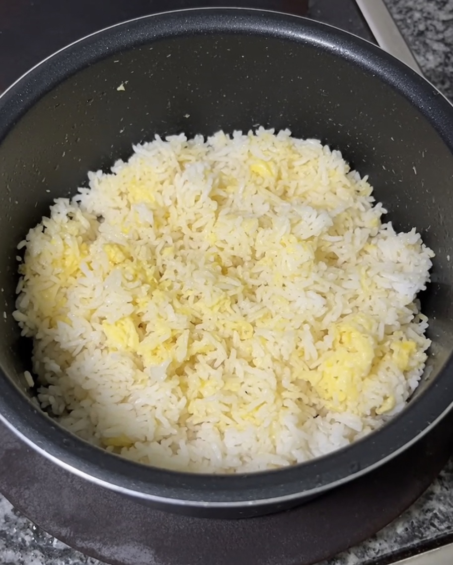 Le riz froid est mélangé avec des jaunes dœufs crus pour obtenir une couleur jaune uniforme.