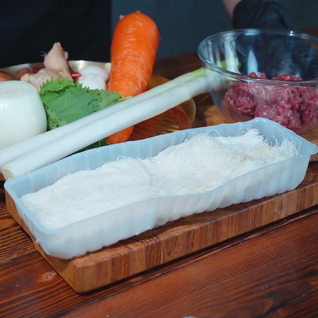 Poireau, champignons shiitakés et oignons hachés sur une planche à découper.