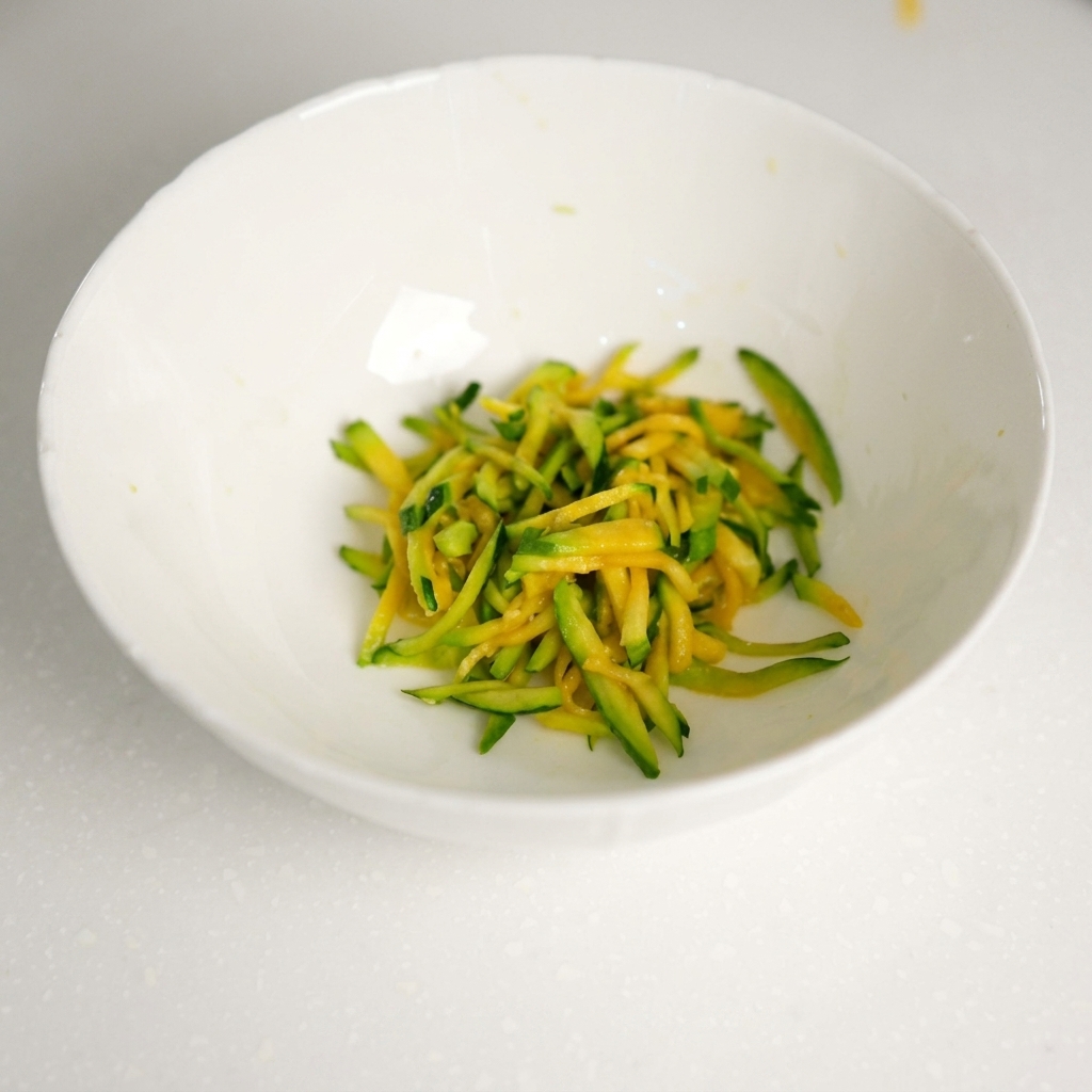 Bœuf haché frais ajouté dans le bol contenant les lamelles de courgette égouttées.