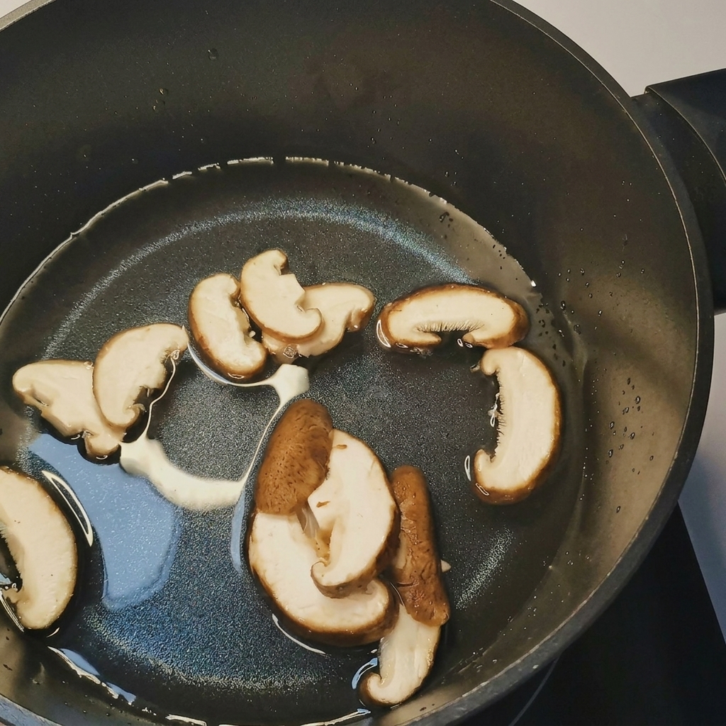 Une casserole deau bouillante avec des champignons tranchés, des pousses de soja et du maïs en cours dajout.
