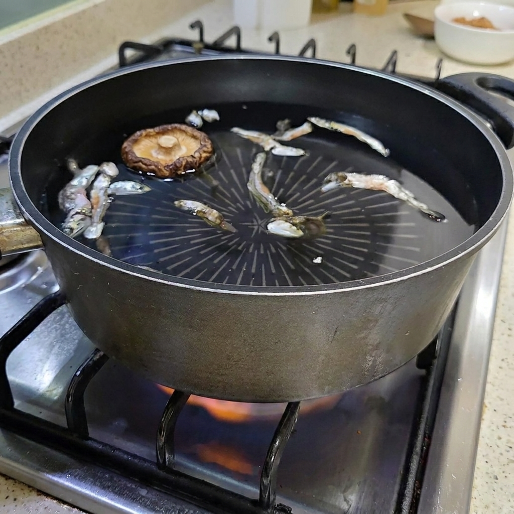 Un champignon shiitake séché flottant dans la marmite deau avec les anchois.