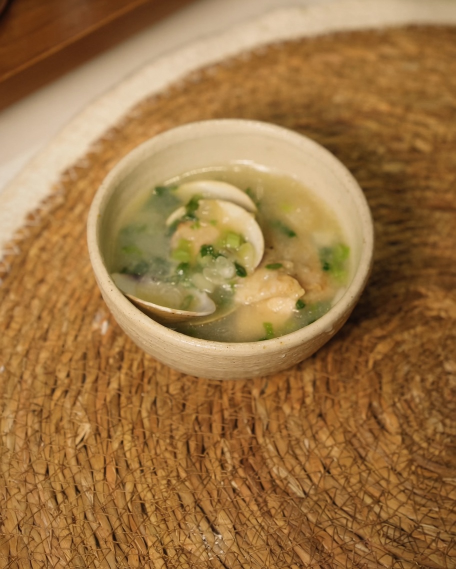 Morceaux de poulet mélangés aux oignons et à lail, avec de leau bouillante versée dans la poêle.