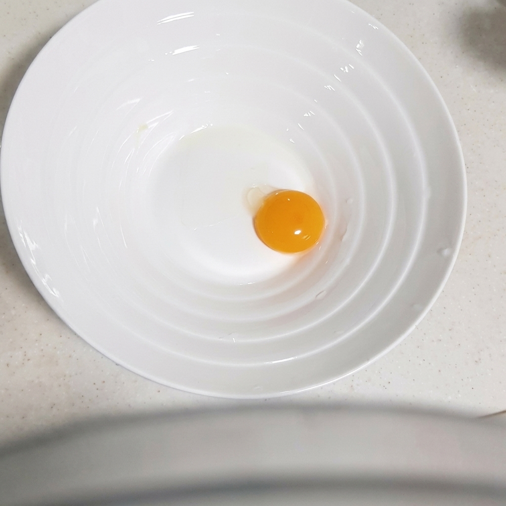 De lail haché ajouté au bol contenant le jaune dœuf.