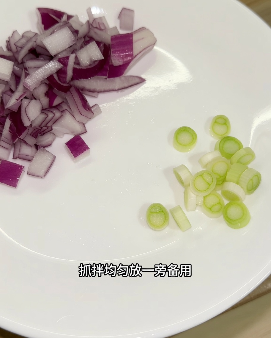 Oignon rouge haché et parties blanches de loignon vert tranchées disposés sur une assiette blanche.