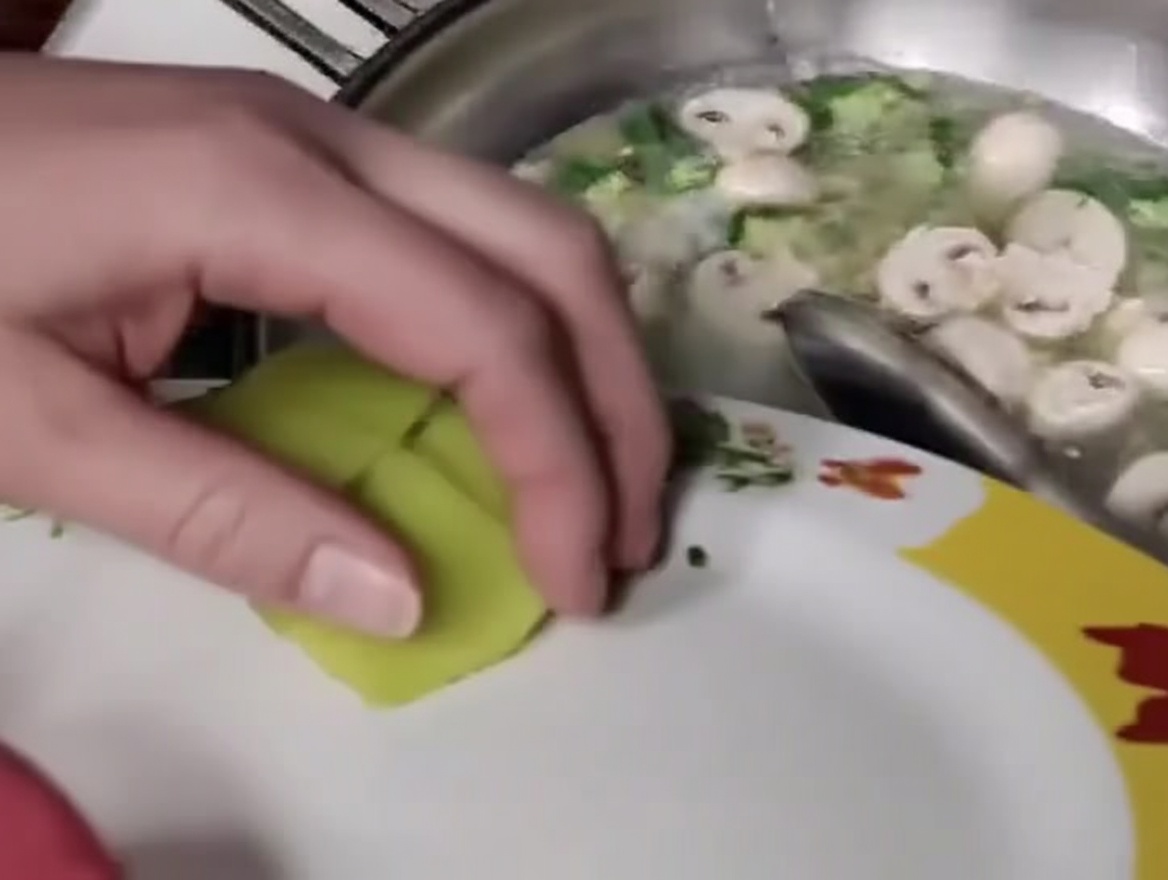 Tranches de pousses de bambou ajoutées au mélange dans le wok.