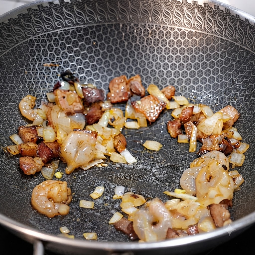 Des crevettes, des morceaux de bacon et des oignons coupés en dés sautant ensemble dans un wok.