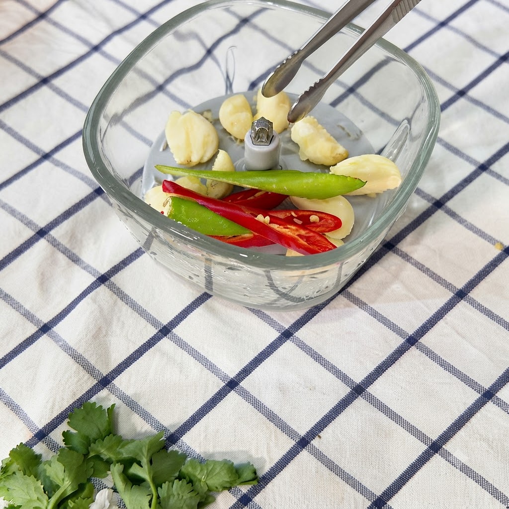 Des piments réduits en pâte dans le hachoir alimentaire.