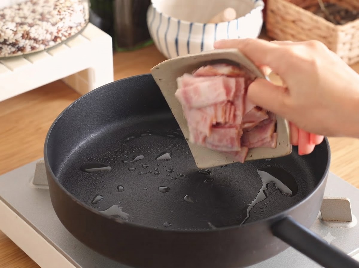Des tranches de bacon qui grésillent dans une poêle avec une petite quantité dhuile.