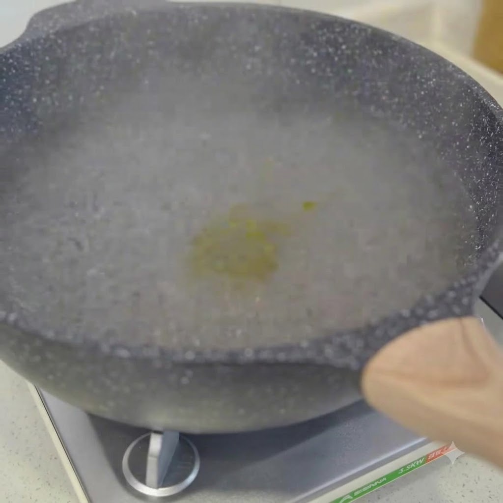 Des spaghettis cuisant dans une casserole deau bouillante remués avec des baguettes.