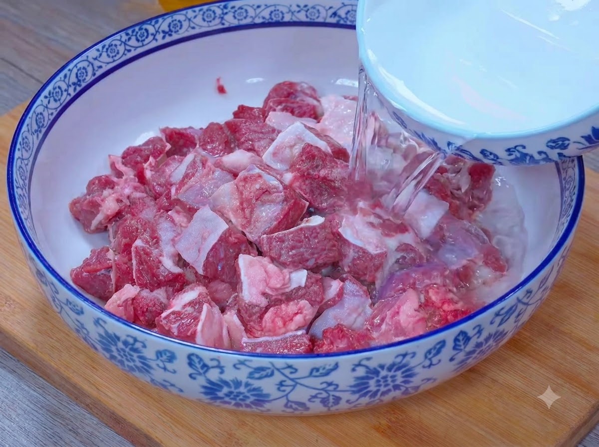 De leau versée dans un bol pour immerger les morceaux de bœuf dans un mélange deau salée et de vinaigre.