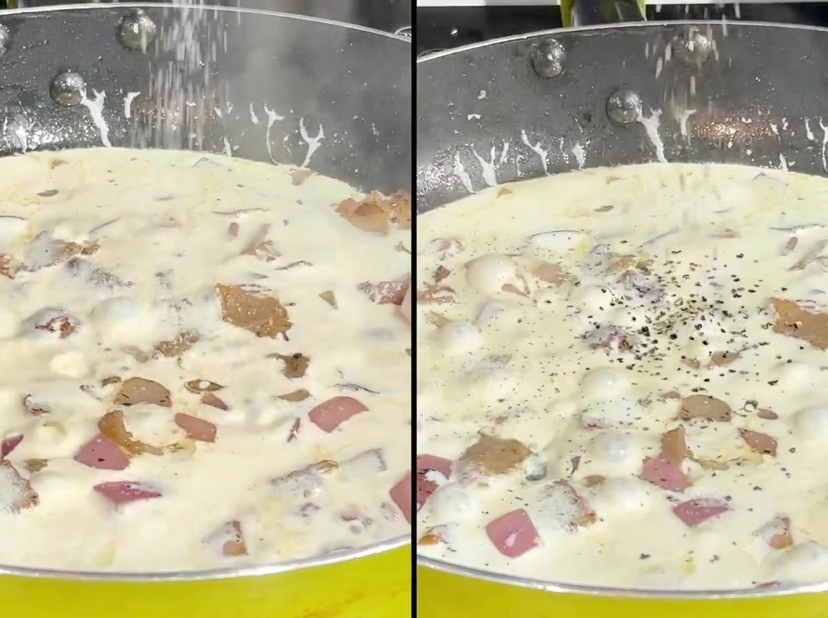 Du sel et du poivre noir concassé saupoudrés sur une sauce à la crème frémissante dans une poêle.